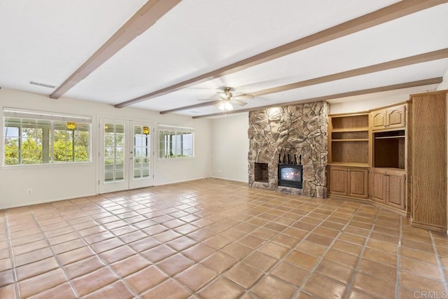 unfurnished living room featuring light tile patterned floors, visible vents, a stone fireplace, and french doors