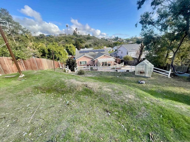 view of yard featuring an exterior structure, an outdoor structure, and fence