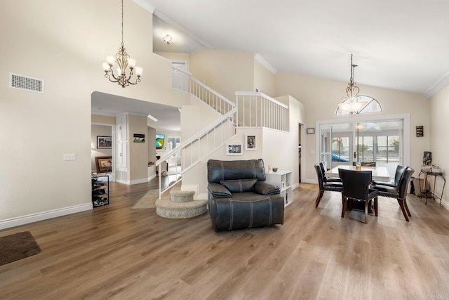 dining space with a notable chandelier, visible vents, light wood-style flooring, and crown molding