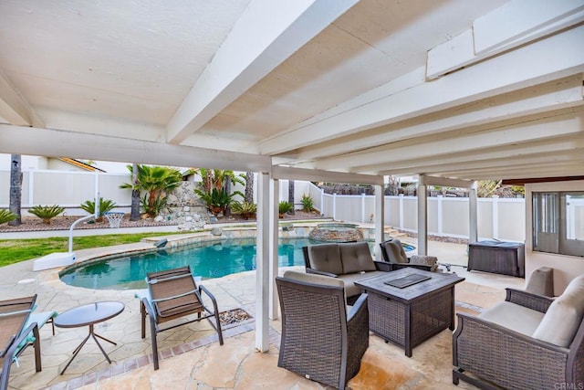 view of swimming pool featuring a patio, a fenced backyard, and a pool with connected hot tub