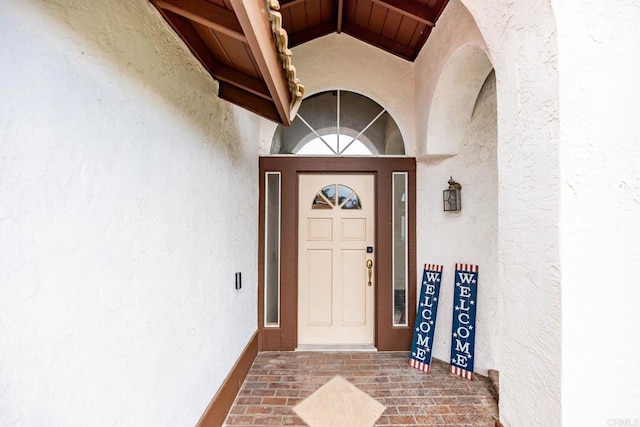 doorway to property featuring stucco siding