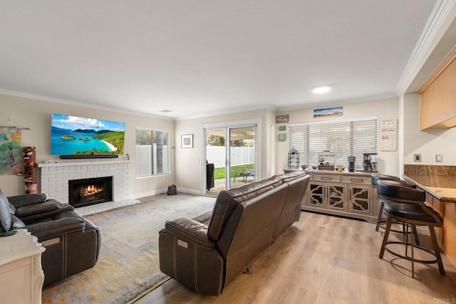 living area with a brick fireplace, light wood-type flooring, and ornamental molding