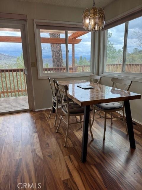 dining room with an inviting chandelier and wood finished floors