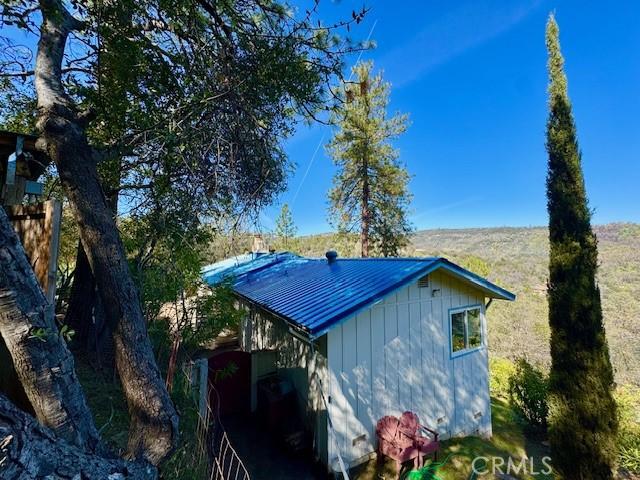 view of side of home with metal roof