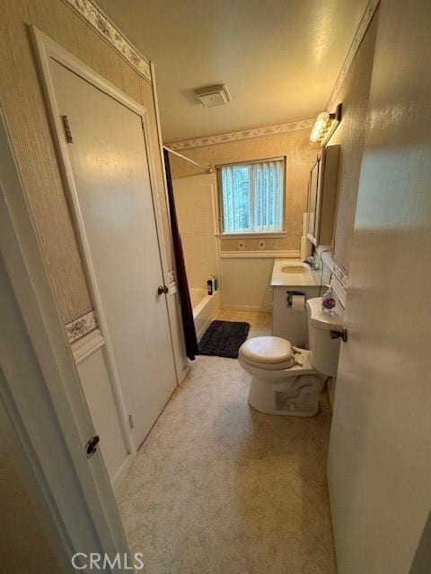 bathroom featuring vanity, toilet, and shower / washtub combination