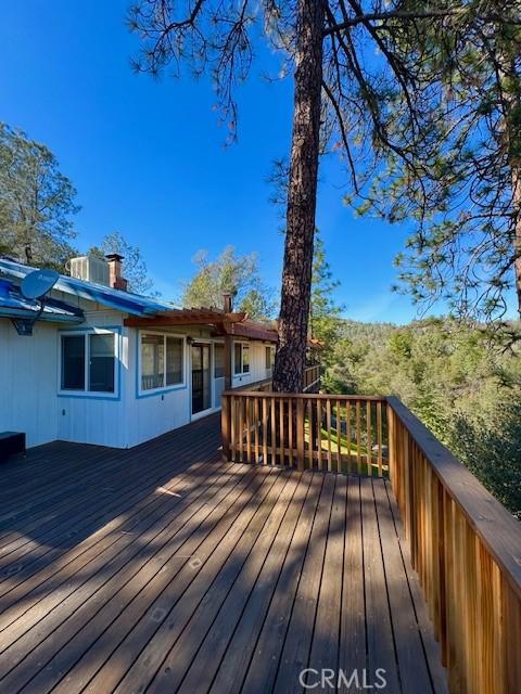 wooden deck with central air condition unit