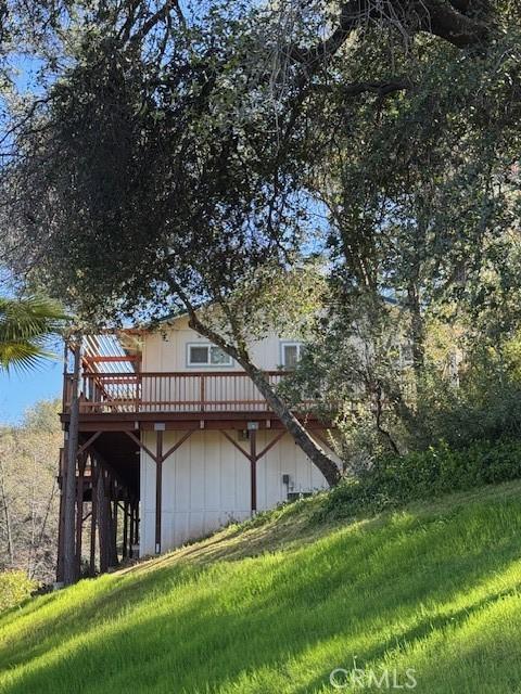 view of home's exterior featuring a wooden deck