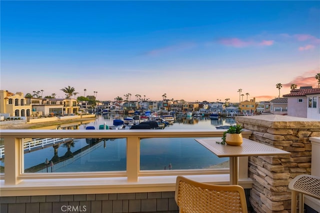 view of swimming pool with a residential view and a water view