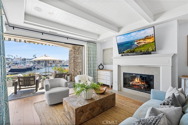 living room with beamed ceiling, recessed lighting, a fireplace, and hardwood / wood-style floors