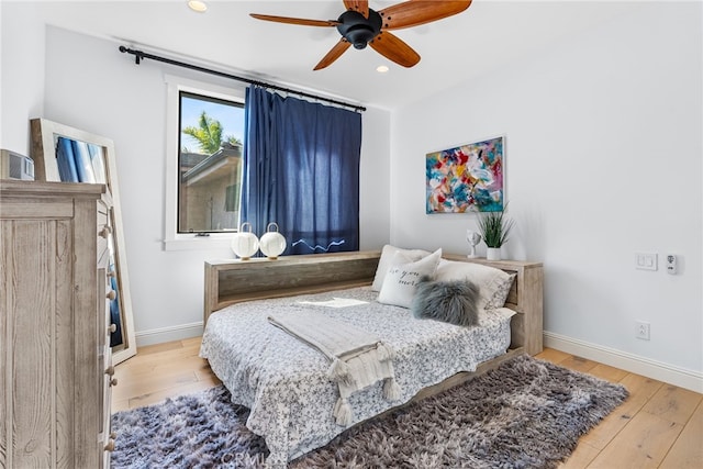 bedroom featuring recessed lighting, ceiling fan, baseboards, and hardwood / wood-style flooring