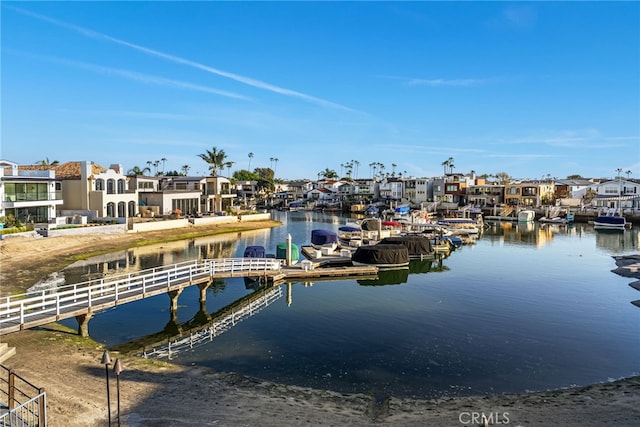 dock area with a residential view and a water view