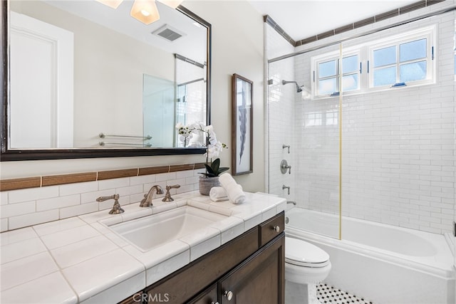 bathroom featuring bathtub / shower combination, toilet, vanity, and visible vents