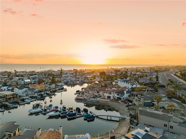 aerial view at dusk with a water view