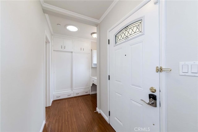 entryway with dark wood-type flooring and crown molding