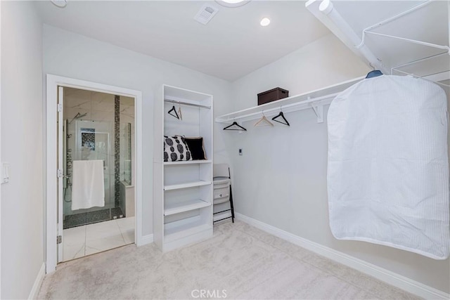 walk in closet with visible vents and carpet floors