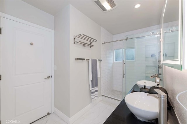 full bathroom featuring visible vents, baseboards, a stall shower, marble finish floor, and a sink