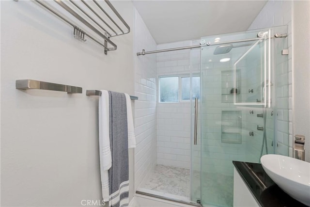 bathroom with a stall shower and vanity