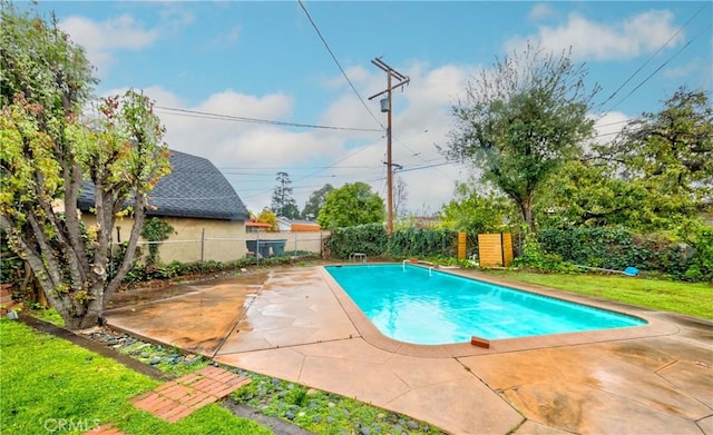 view of pool featuring a fenced in pool, a patio, a lawn, and a fenced backyard