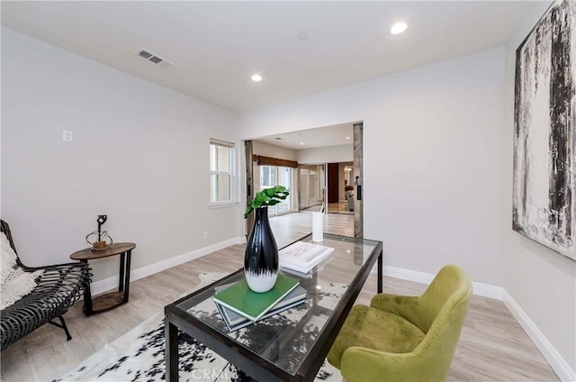 office space with visible vents, recessed lighting, light wood-style floors, and baseboards