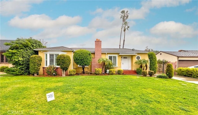 view of front of home with a front yard, stucco siding, and a chimney