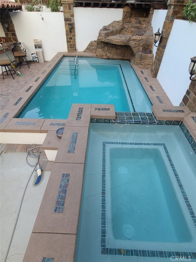 view of pool featuring a pool with connected hot tub