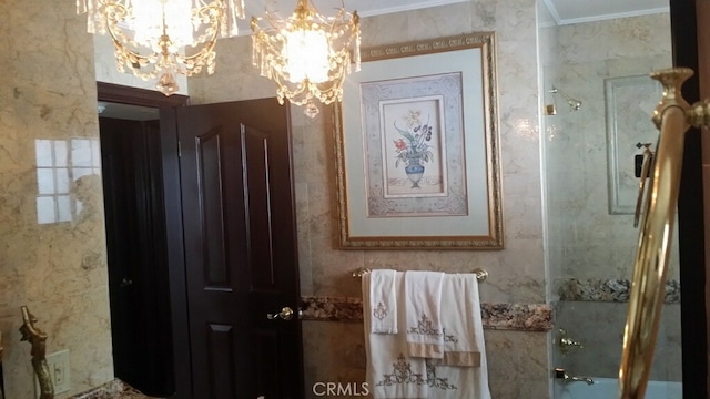 bathroom featuring ornamental molding, a shower with shower door, and a chandelier