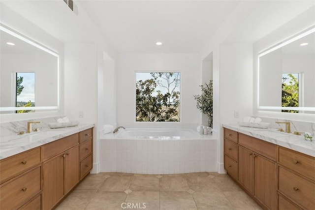 15 Cavaillon, Newport Coast, CA 92657 - full bathroom featuring two vanities, healthy amount of natural light, a garden tub, tile patterned flooring, and recessed lighting