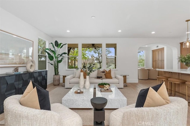 15 Cavaillon, Newport Coast, CA 92657 - living room featuring arched walkways, light wood-style flooring, recessed lighting, and ceiling fan