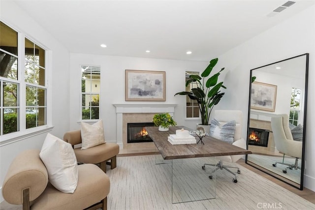 office area with recessed lighting, visible vents, wood finished floors, and a high end fireplace