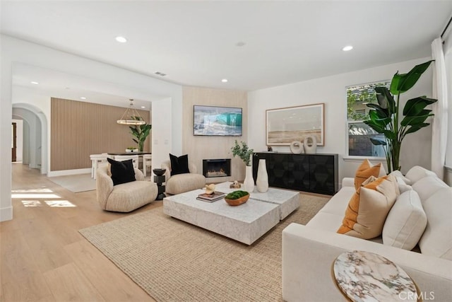 15 Cavaillon, Newport Coast, CA 92657 - living area with arched walkways, light wood finished floors, recessed lighting, and a fireplace