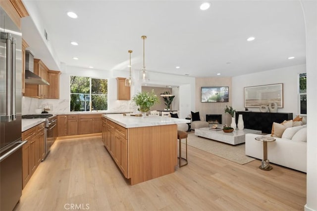 15 Cavaillon, Newport Coast, CA 92657 - kitchen with premium appliances, wall chimney exhaust hood, open floor plan, light wood-type flooring, and recessed lighting