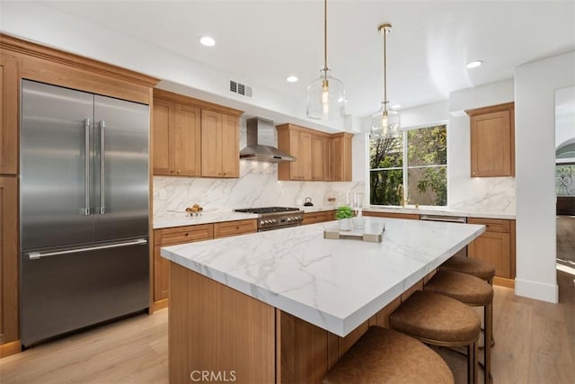 15 Cavaillon, Newport Coast, CA 92657 - kitchen with high quality appliances, wall chimney range hood, light wood-style flooring, tasteful backsplash, and recessed lighting