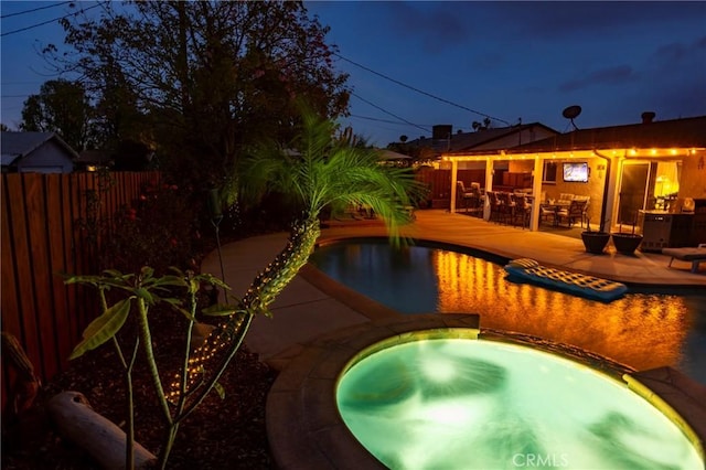 view of pool with a patio area, a fenced in pool, an in ground hot tub, and fence