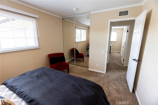 bedroom featuring crown molding, carpet flooring, visible vents, and a closet