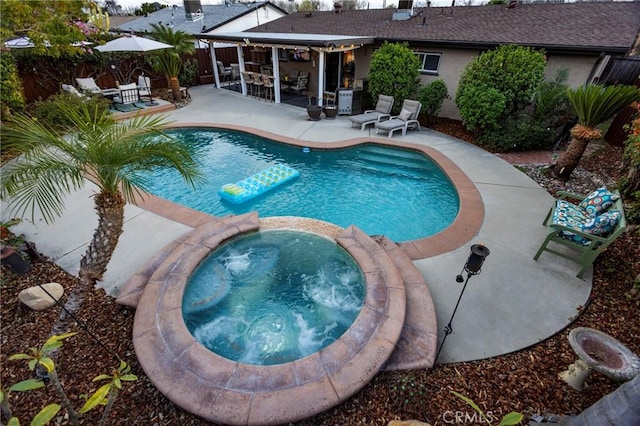 view of pool featuring a patio area, a pool with connected hot tub, and fence