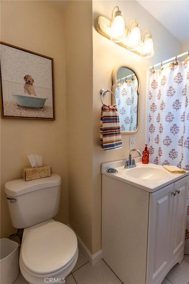 bathroom featuring tile patterned floors, toilet, vanity, and baseboards