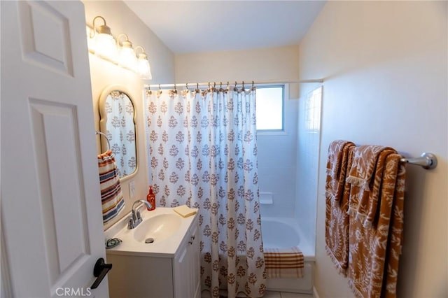 bathroom featuring shower / tub combo and vanity