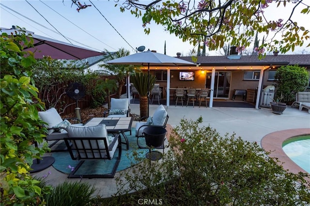 view of patio featuring an outdoor living space, fence, and outdoor dry bar