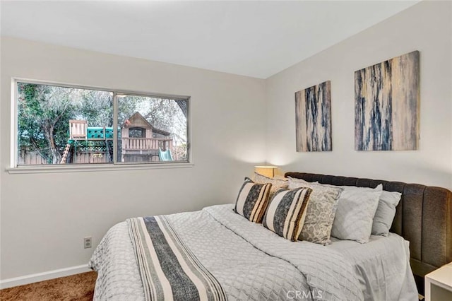 carpeted bedroom featuring baseboards