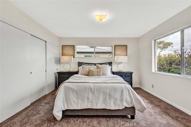 bedroom with a closet, baseboards, and carpet flooring