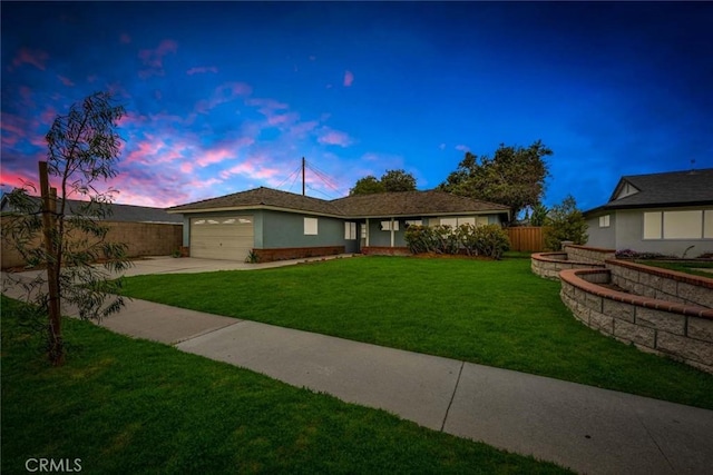 ranch-style home with stucco siding, a lawn, fence, concrete driveway, and a garage