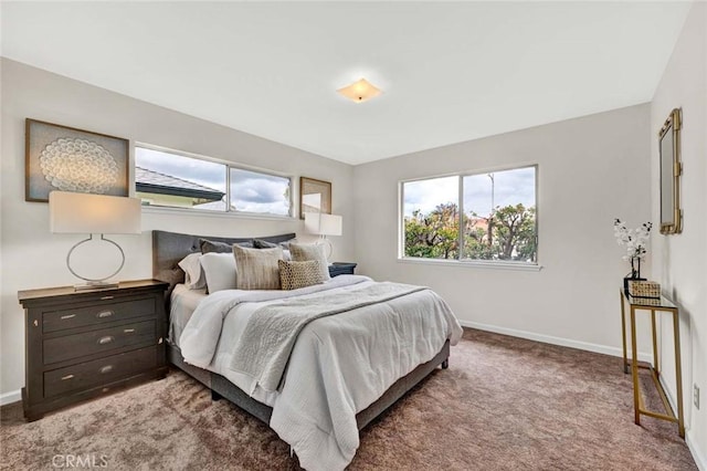 carpeted bedroom featuring baseboards