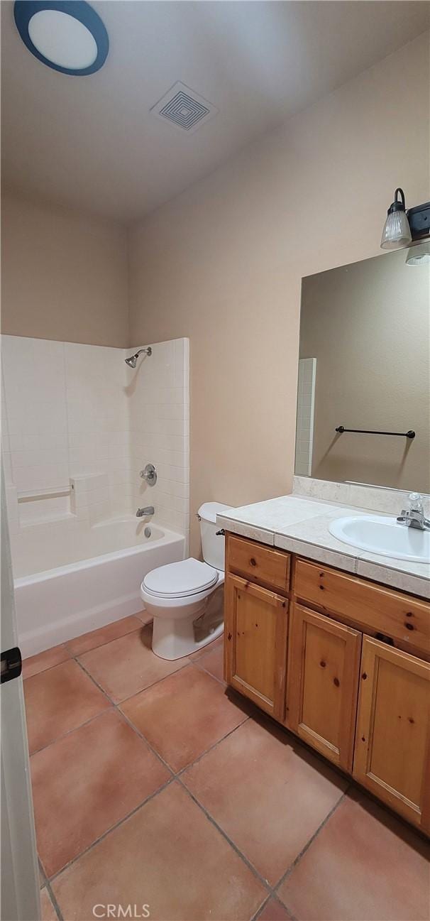 full bathroom with tile patterned flooring, visible vents, toilet, shower / bathtub combination, and vanity