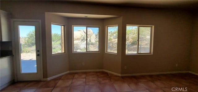 unfurnished sunroom featuring a wealth of natural light