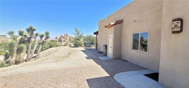 view of side of property featuring a patio area and stucco siding