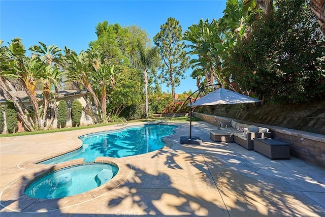 view of pool with a patio area and a pool with connected hot tub