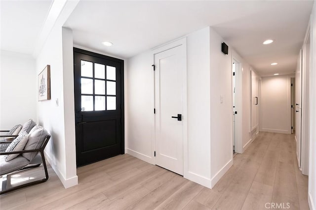 foyer with recessed lighting, light wood-type flooring, and baseboards