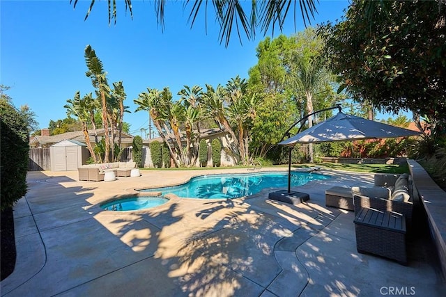 view of pool featuring an outdoor living space, a pool with connected hot tub, an outdoor structure, a patio area, and a storage unit