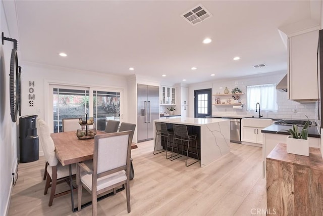 dining space with recessed lighting, visible vents, and light wood finished floors