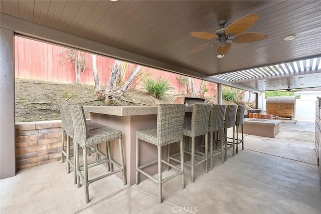 view of patio featuring ceiling fan and an outdoor kitchen